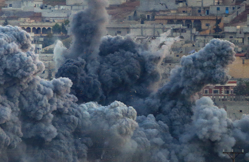  An explosion following an airstrike is seen in the Syrian town of Kobani from near the Mursitpinar border crossing on the Turkish-Syrian border in the southeastern town of Suruc (photo credit: REUTERS)