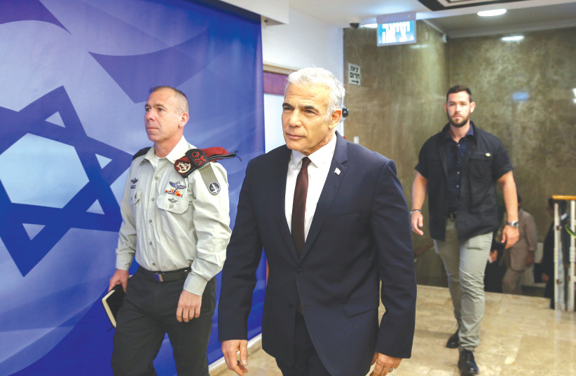  RIME MINISTER Yair Lapid arrives for a cabinet meeting at the Prime Minister’s Office in Jerusalem (photo credit: ALEX KOLOMOISKY/FLASH90)