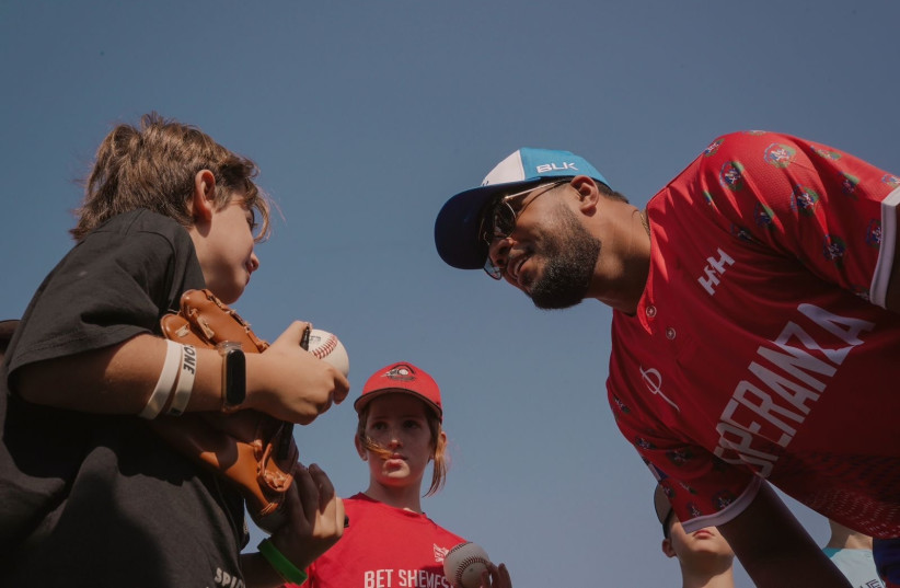  Jeimer Candelario, a third baseman for the Detroit Tigers, interacts with children at the Raanana field. (credit: NICO ANDRE DURAN/JTA)