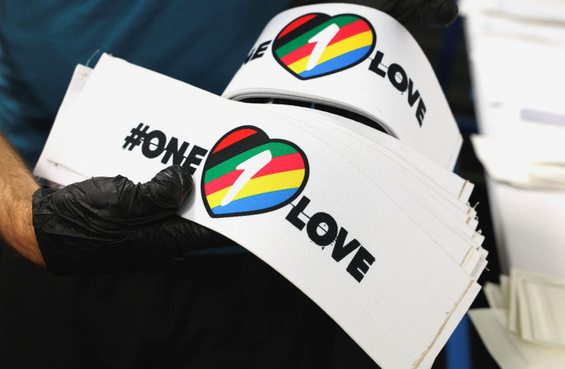 A worker carries One Love armbands, which are banned by FIFA at the World Cup Qatar 2022, in Utrecht, Netherlands November 23, 2022.  (photo credit:  REUTERS/STAFF)