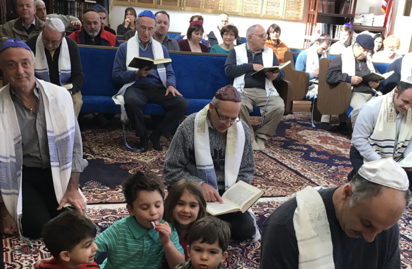  It is a custom among Karaite Jews to pray kneeling on the ground, as seen here in the sanctuary of Congregation B’nai Israel in Daly City (credit: KARARITE JEWS OF AMERICA)