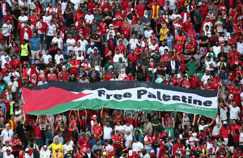  Fans unveil a banner with the message 'Free Palestine', November 26, 2022. (photo credit: REUTERS/MARKO DJURICA)