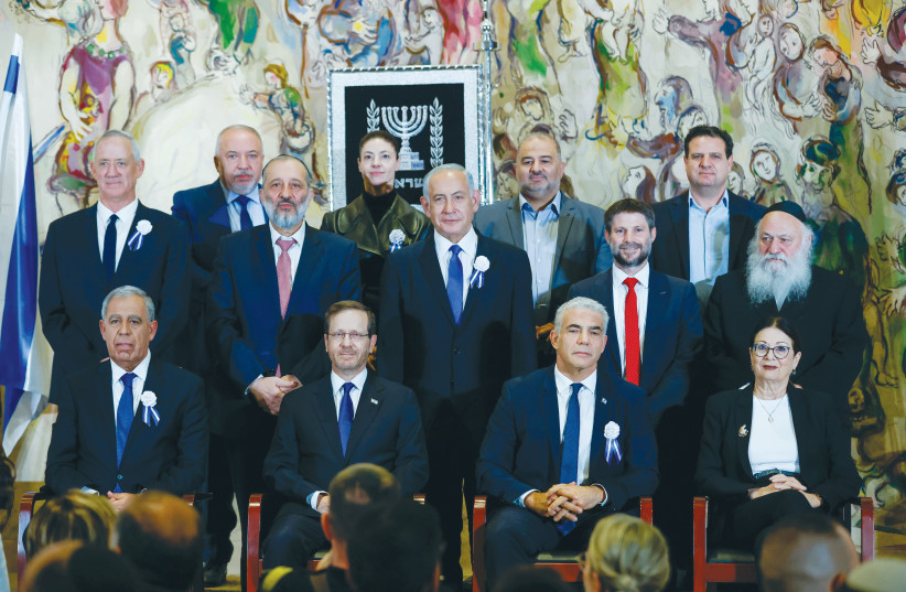 PRESIDENT ISAAC Herzog and Prime Minister Yair Lapid sit at the center of the front row, with MK Benjamin Netanyahu behind them, in a Knesset inauguration photo earlier this month. Herzog emphasized that Israelis are exhausted from infighting. (photo credit: OLIVIER FITOUSSI/FLASH90)