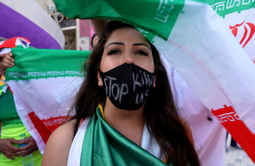  A woman wearing a facemask with a message reading 'stop killing us' after the Wales v Iran match (photo credit: REUTERS/CHARLOTTE BRUNEAU)