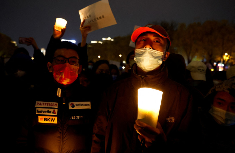  Vigil commemorating victims of a fire in Urumqi, in Beijing (credit: REUTERS)