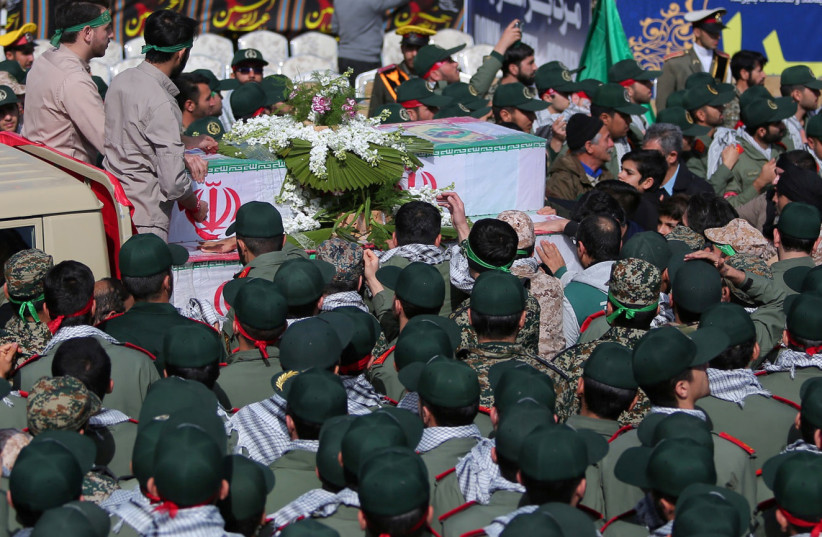  Members of Iran's elite Revolutionary Guards, gather around the coffins of their fellow guards, who were killed by a suicide car bomb, during the funerals in Isfahan, Iran February 16, 2019.  (photo credit:  MORTEZA SALEHI/TASNIM NEWS AGENCY/VIA REUTERS )