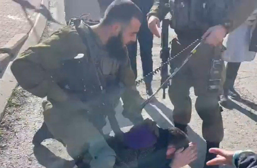  Soldiers confront left-wing activists in Hebron, November 25, 2022. (credit: Issa Amro and Tal Sagi/Screenshot)