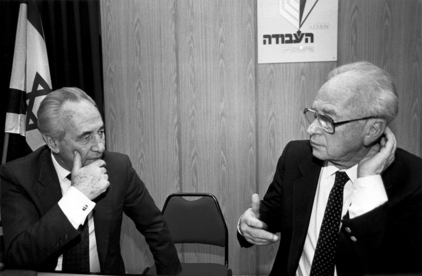  THEN-PRIME minister Yitzhak Rabin and his foreign minister Shimon Peres confer at a Labor Party meeting in 1993.  (photo credit: MOSHE SHAI/FLASH90)