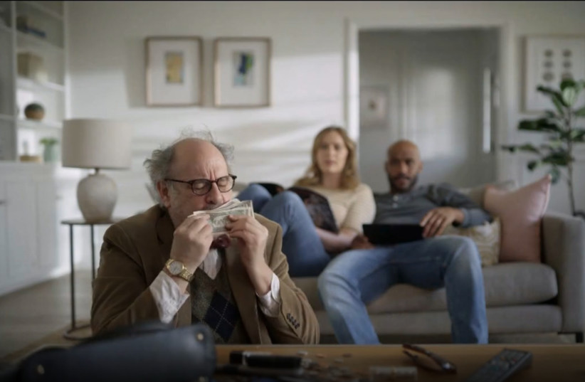  An ad for student debt refinancing company SoFi depicts a man stealing money whom one critic accused of being an antisemitic stereotype. (Screenshot) (photo credit: JTA)