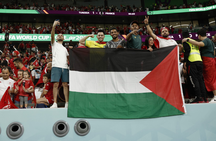  FIFA World Cup Qatar 2022 - Group D - Tunisia v France - Education City Stadium, Al Rayyan, Qatar - November 30, 2022 The flag of Palestine is displayed in the stands after the match. (credit: BENOIT TESSIER/REUTERS)