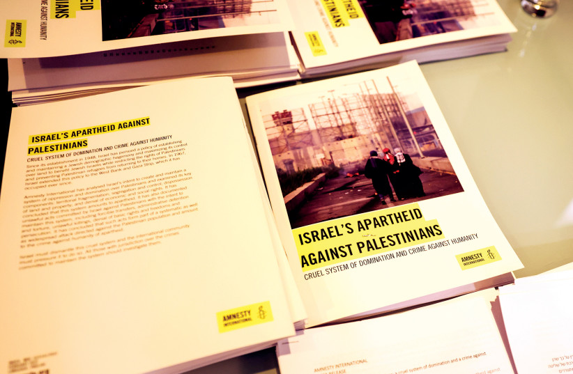  Copies of Amnesty International’s report titled ‘Israel’s Apartheid Against Palestinians: Cruel System of Domination and Crime Against Humanity’ are seen at a press conference at the St. George Hotel in Jerusalem on February 1, 2022.  (credit: RONEN ZVULUN/REUTERS)