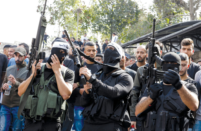  Palestinian gunmen attend the funeral of their Lions’ Den comrade Tamer Kilani, who was killed in an explosion, in Nablus on October 23, 2022.  (photo credit: RANEEN SAWAFTA/ REUTERS)