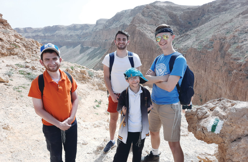   DIVERSE group of students and madrichim from Yeshivat Darkaynu explore the Judean Desert. (photo credit: Avi Ganz)