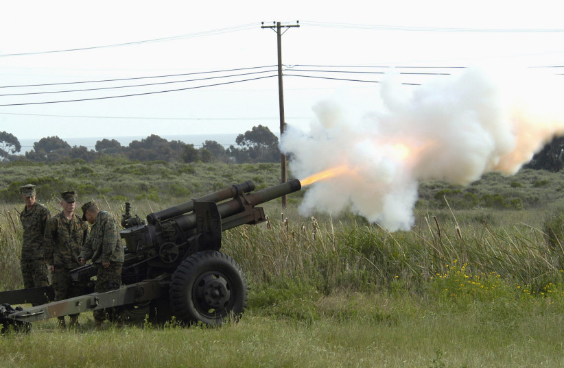 Marines from 11th Marines, 1st Marine Division fire a M101 105 mm Howitzer during the playing of taps at the Iwo Jima 60th Anniversary Commemorative on 26 March 2005. Camp Pendleton, California. (credit: US ARMY)