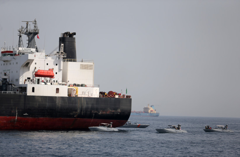  UAE Navy boats are seen next to Al Marzoqah, Saudi Arabian tanker, off the Port of Fujairah, UAE May 13, 2019. (photo credit: SATISH KUMAR/REUTERS)