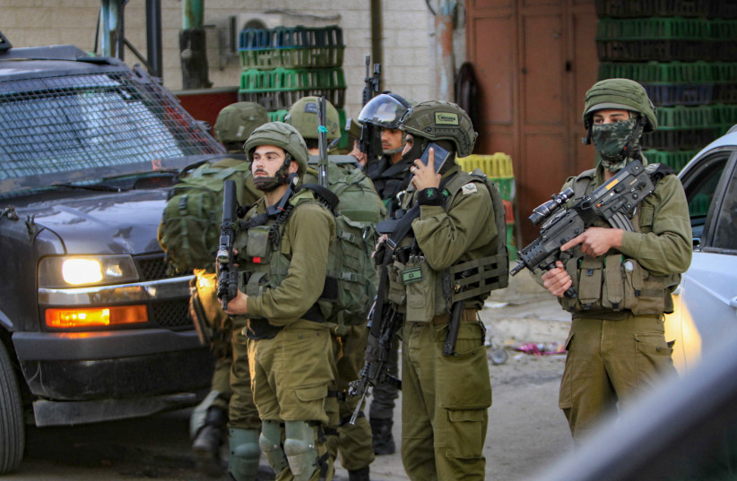 IDF soldiers secure the scene after a Border Police officer was stabbed in Huwara, December 2, 2022. (photo credit: NASSER ISHTAYEH/FLASH90)