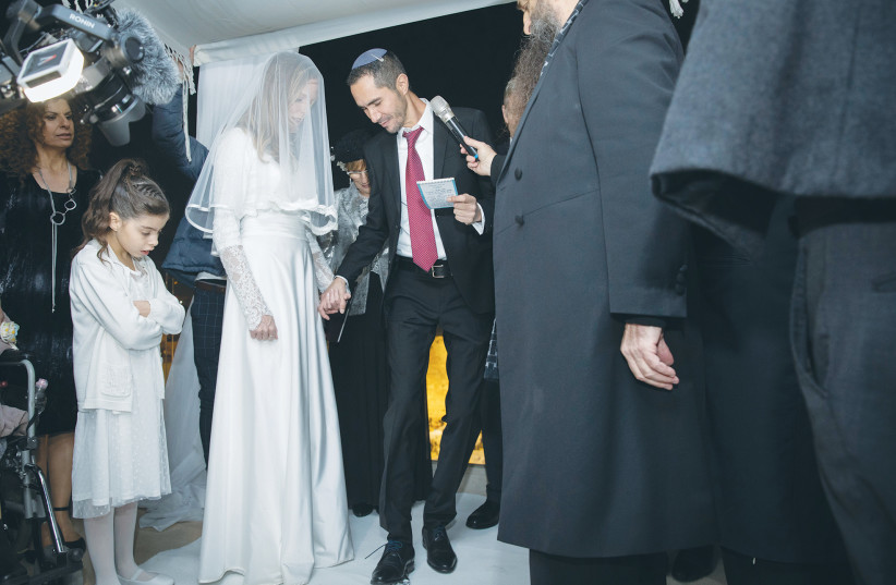  THE GROOM breaks a glass, the traditional conclusion of a Jewish wedding ceremony. We have witnessed a narrowing of ethnic gaps and greater intermingling of Ashkenazim and Mizrahim, perhaps most significantly in ethnic intermarriage, says the writer.  (photo credit: OLIVIER FITOUSSI/FLASH90)