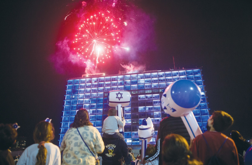  REVELERS WATCH a fireworks display on Independence Day in Tel Aviv, last year. Immigrant grandchildren of Jews will come to value a restful Shabbat and the excitement of Independence Day and will undoubtedly teach it to their own children, says the writer. (photo credit: MIRIAM ALSTER/FLASH90)