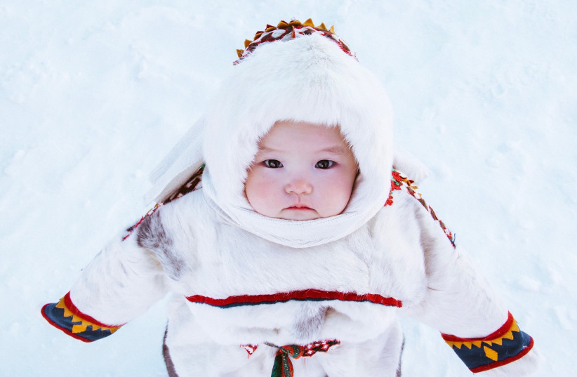  A baby in snow (photo credit: PEXELS)