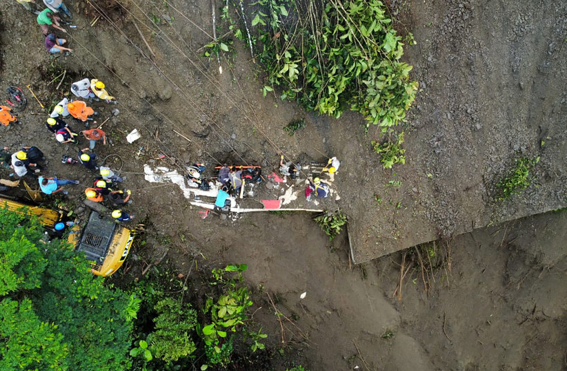  aerial view of the rescue operations of a bus that was buried after a landslide due to heavy rains in Pueblo Rico, Colombia December 5, 2022 (photo credit: COLOMBIAN CIVIL DEFENSE/HANDOUT VIA REUTERS)
