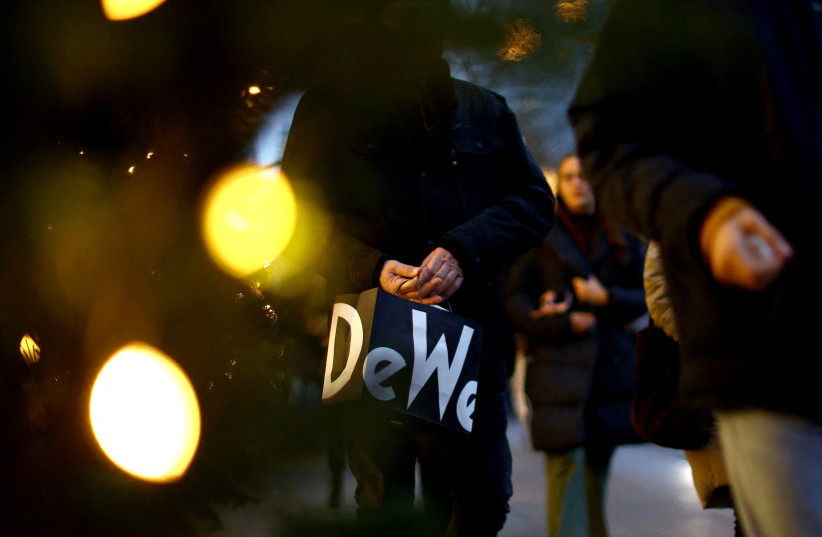  A person with a shopping bag of the department store Kaufhaus des Westens ''KaDeWe'' walks along Kurfuerstendamm shopping street looking for bargains on the second weekend of advent, in Berlin, Germany, December 3, 2022 (credit: REUTERS/LISI NIESNER)