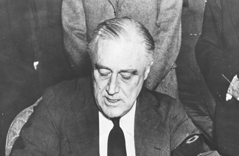  US PRESIDENT Franklin Delano Roosevelt signs the declaration of war on Japan, in Washington, on December 8, 1941. Unknown at the time to the Allies or the Jews of Europe, Roosevelt’s day that would live in infamy was also the first day of the ‘Final Solution,’ writes Sir Martin Gilbert.  (photo credit: US National Archives and Records Administration/Reuters)