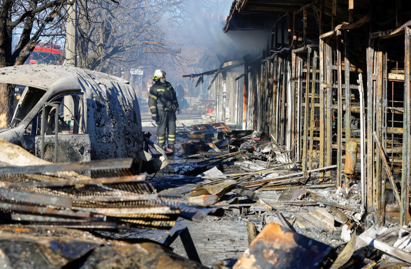  A firefighter stands in front of burnt market stalls hit by shelling in the course of Russia-Ukraine conflict in Donetsk, Russian-controlled Ukraine, December 6, 2022. (credit: REUTERS/ALEXANDER ERMOCHENKO)