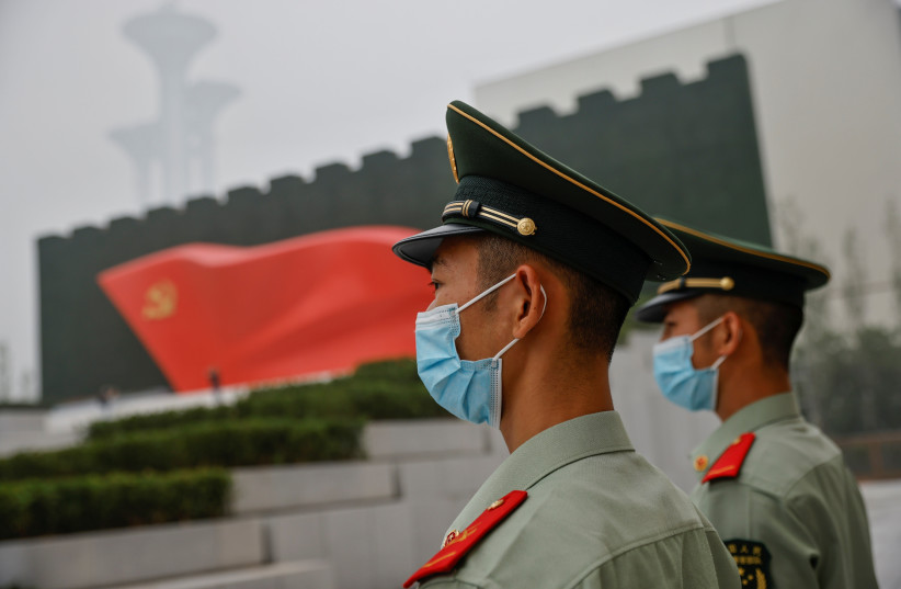  Officers of the People's Armed Police stand guard outside the Museum of the Communist Party of China that was opened ahead of the 100th founding anniversary of Party in Beijing, China June 25, 2021. (photo credit:  REUTERS/THOMAS PETER)