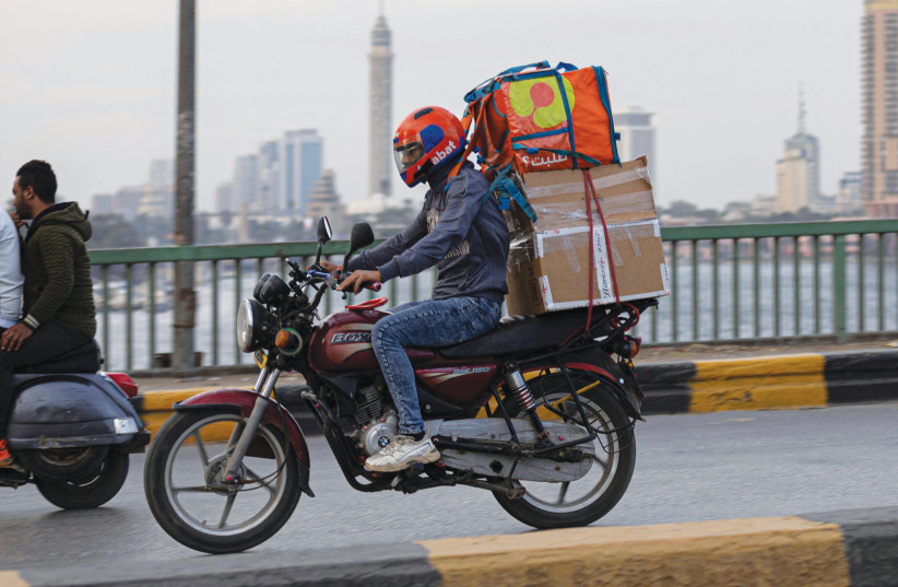  MAKING DELIVERIES in Cairo.  (credit: Khaled Desouki/AFP via Getty Images)
