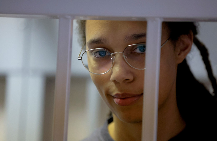  US basketball player Brittney Griner, who was detained at Moscow's Sheremetyevo airport and later charged with illegal possession of cannabis, stands inside a defendants' cage before a court hearing in Khimki outside Moscow, Russia August 4, 2022 (credit: REUTERS/Evgenia Novozhenina/Pool/File Photo )