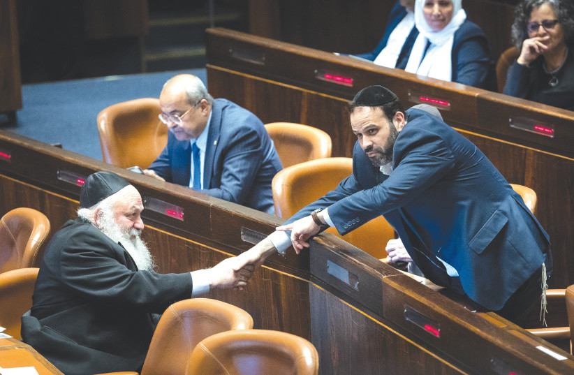  PROSPECTIVE COALITION partners UTJ MK Yitzhak Goldknopf and Shas MK Yinon Azoulay shake hands in the Knesset as MK Ahmed Tibi looks on. (photo credit: YONATAN SINDEL/FLASH90)