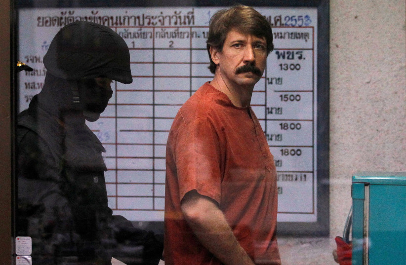  Alleged arms smuggler Viktor Bout from Russia is escorted by a member of the special police unit as he arrives at a criminal court in Bangkok October 4, 2010. (credit: Damir Sagolj/Reuters)