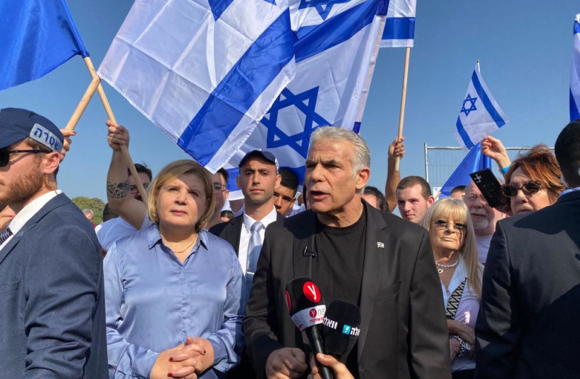  Prime Minister Yair Lapid speaks to the press as he joins his supporters in a protest against the incoming government on December 9, 2022 at the KKL Bridge in Jerusalem. (photo credit: AVSHALOM SASSONI/MAARIV)
