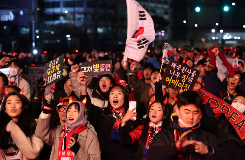  South Korean soccer fans react as they watch the FIFA World Cup Qatar 2022 match between South Korea and Brazil in Seoul, South Korea December 6, 2022 (photo credit: YONHAP VIA REUTERS)