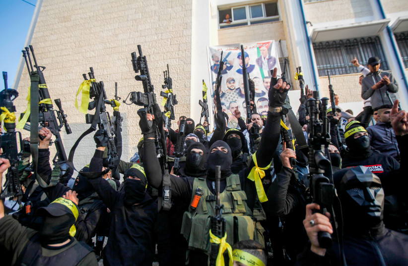  Palestinian gunmen from the Balata Brigade of the Fatah movement's Lions' Den groups carry their weapons during a festival in the Askar refugee camp in the West Bank, December 9, 2022.  (credit: NASSER ISHTAYEH/FLASH90)