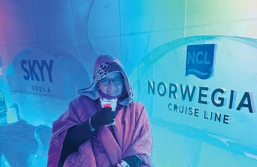  IN THE SKYY Vodka Ice Bar, passengers don colorful ponchos and gloves to drink from ice glasses while sitting on an ice throne in the -8°Celsius chill. (credit: LAURI DONAHUE)