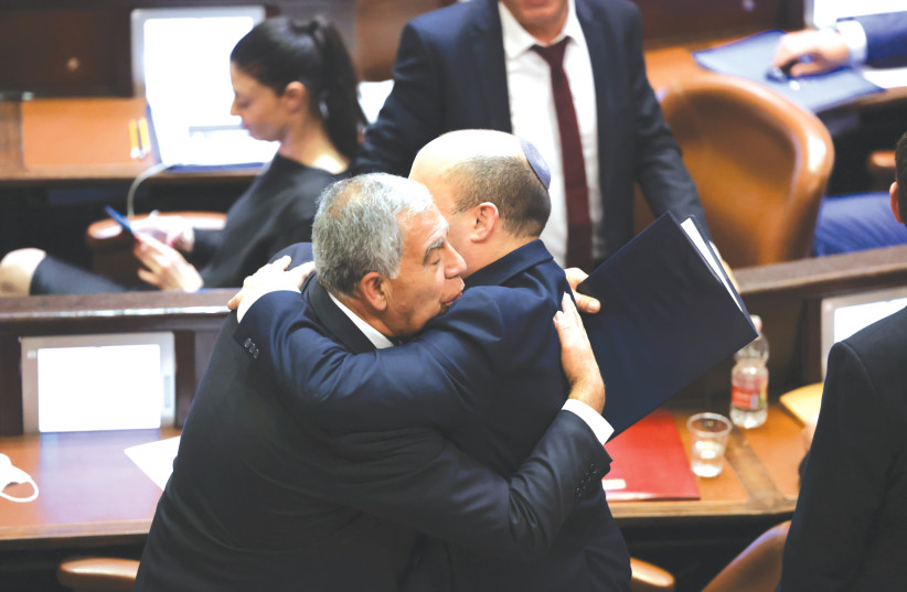  NAFTALI BENNETT and Mickey Levy embrace in the Knesset plenum, after the inauguration of Bennett’s government and the election by MKs of Levy as the new speaker, June 2021.  (photo credit: OLIVIER FITOUSSI/FLASH90)