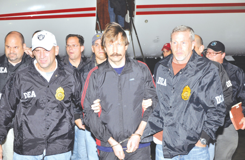  VIKTOR BOUT is escorted by US Drug Enforcement Administration officers after arriving in New York, 2010. (photo credit: US Department of Justice/Reuters)