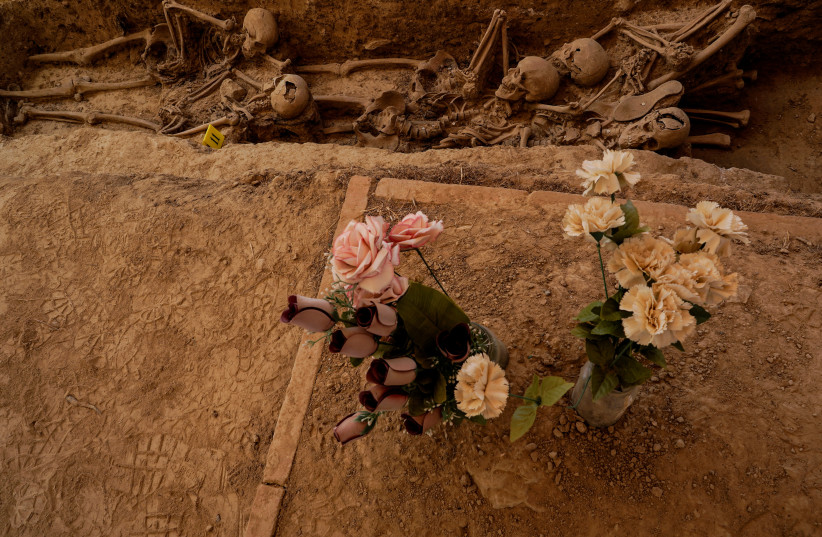  The remains of bodies that have been shot in 1937 by forces of dictator Francisco Franco are seen during the exhumation of a mass grave at Los Martires cemetery in Huesca (photo credit: REUTERS)
