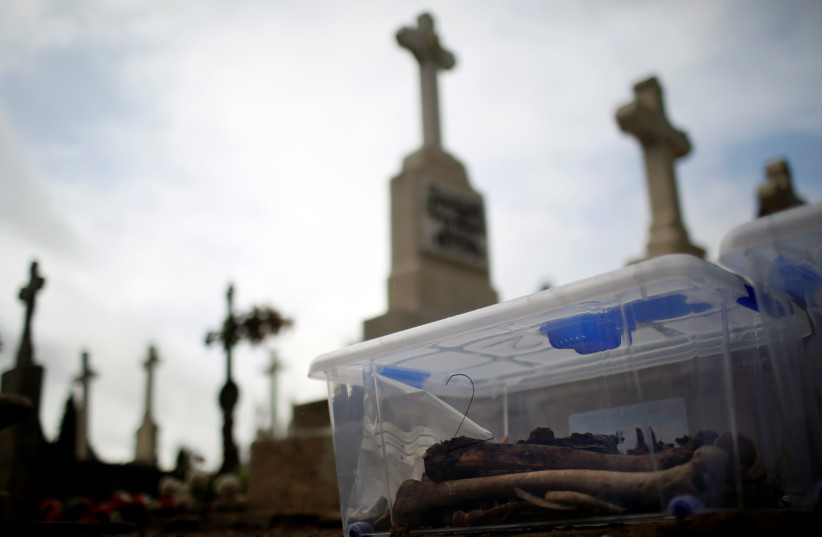  The remains of bodies are pictured during the exhumation of the one of the three mass graves that contain in total the remains of around 200 bodies believed to have been killed by Spain's late dictator Francisco Franco's forces during the civil war, at El Carmen's cemetery in Valladolid, Spain (credit: REUTERS)