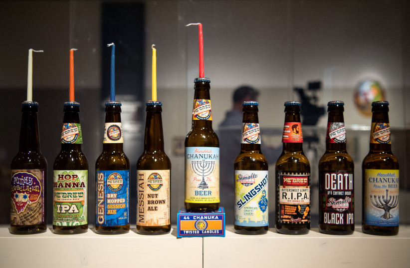  Various beer bottles by Shmaltz Brewery on display in an exhibition on "Jewish brewing stories" at the Jewish Museum in Munich, Germany, April 11, 2016.  (photo credit: Sven Hoppe/picture alliance via Getty Images)