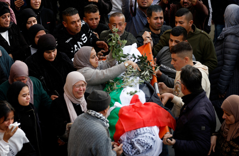  Mourners carry the body of Palestinian Jana Zakarneh during her funeral, in Jenin, in the Israeli-occupied West Bank, December 12, 2022. (photo credit: MOHAMAD TOROKMAN/REUTERS)