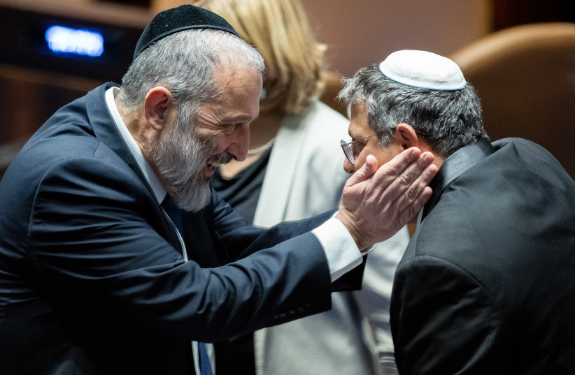  MK Itamar Ben Gvir speaks with MK Aryeh Deri during a vote for the new Knesset speaker at the assembly hall of the Knesset, the Israeli parliament in Jerusalem, on December 13, 2022.  (photo credit: YONATAN SINDEL/FLASH90)