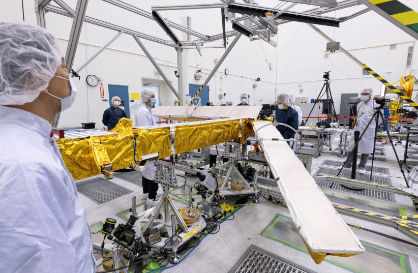 Members of the international Surface Water and Ocean Topography (SWOT) radar satellite mission test one of the antennas for the Ka-band Radar Interferometer (KaRIn) instrument in a clean room at NASA's Jet Propulsion Laboratory in Pasadena, California in 2022. (credit: NASA/JPL-CALTECH/HANDOUT VIA REUTERS)