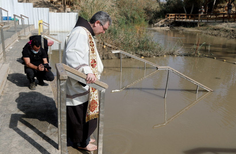  Custodian of the Holy Land, Father Francesco Patton, stands by the Jordan River during a baptism ceremony, near Jericho, in the West Bank, January 9, 2022. (photo credit: REUTERS/RANEEN SAWAFTA)