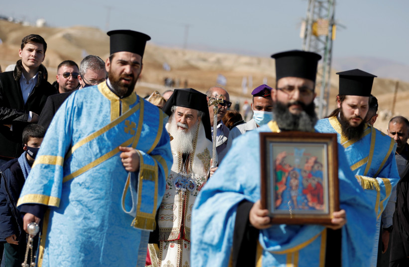  Greek Orthodox Patriarch of Jerusalem Theophilos III participates in a baptism ceremony at the Jordan River to celebrate Epiphany, in what is believed to be the site of Jesus' baptism, near Jericho in the West Bank January 18, 2022. (credit: REUTERS/RANEEN SAWAFTA)
