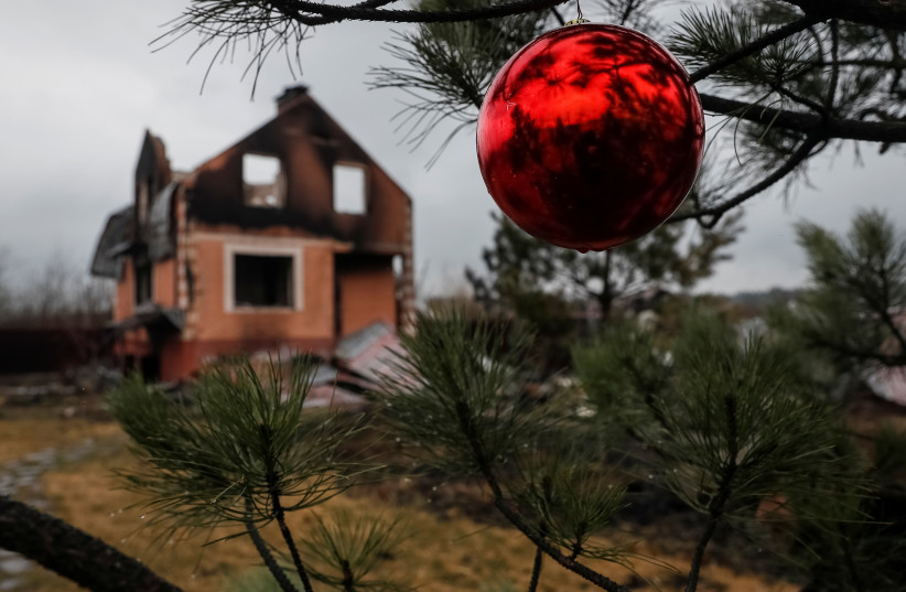  A destroyed house is seen as Christmas ball hangs on a branch on the front line near Kyiv as Russia's invasion of Ukraine continues, Ukraine March 30, 2022. (credit: GLEB GARANICH/REUTERS)