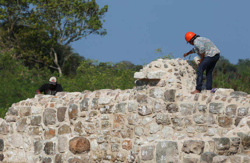  Workers of Mexico's National Institute of Anthropology and History (INAH) work on the restoration of the archaeological zone of Oxkintok, in Maxcanu, state of Yucatan, in Mexico, December 7, 2022.  (credit: REUTERS/Lorenzo Hernandez)