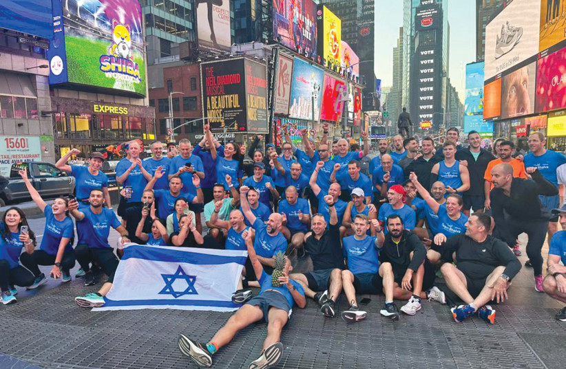  Team Shalva at the New York Marathon pose for a photograph in Times Square. (photo credit: AVISHAI FINKELSTEIN)