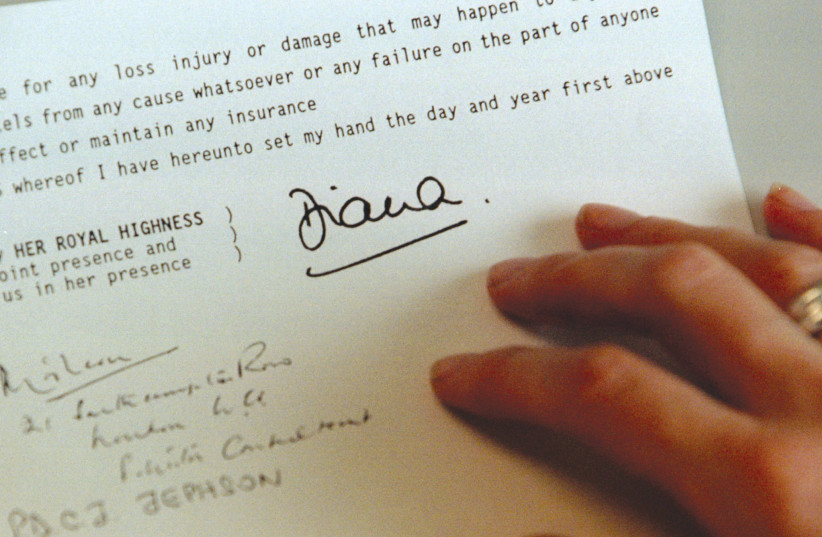  A journalist studies a copy of Princess Diana’s last will and testament. Diana left more than 21 millions pounds, the bulk of which is being held in trust for her two sons, princes William and Harry. (credit: REUTERS)